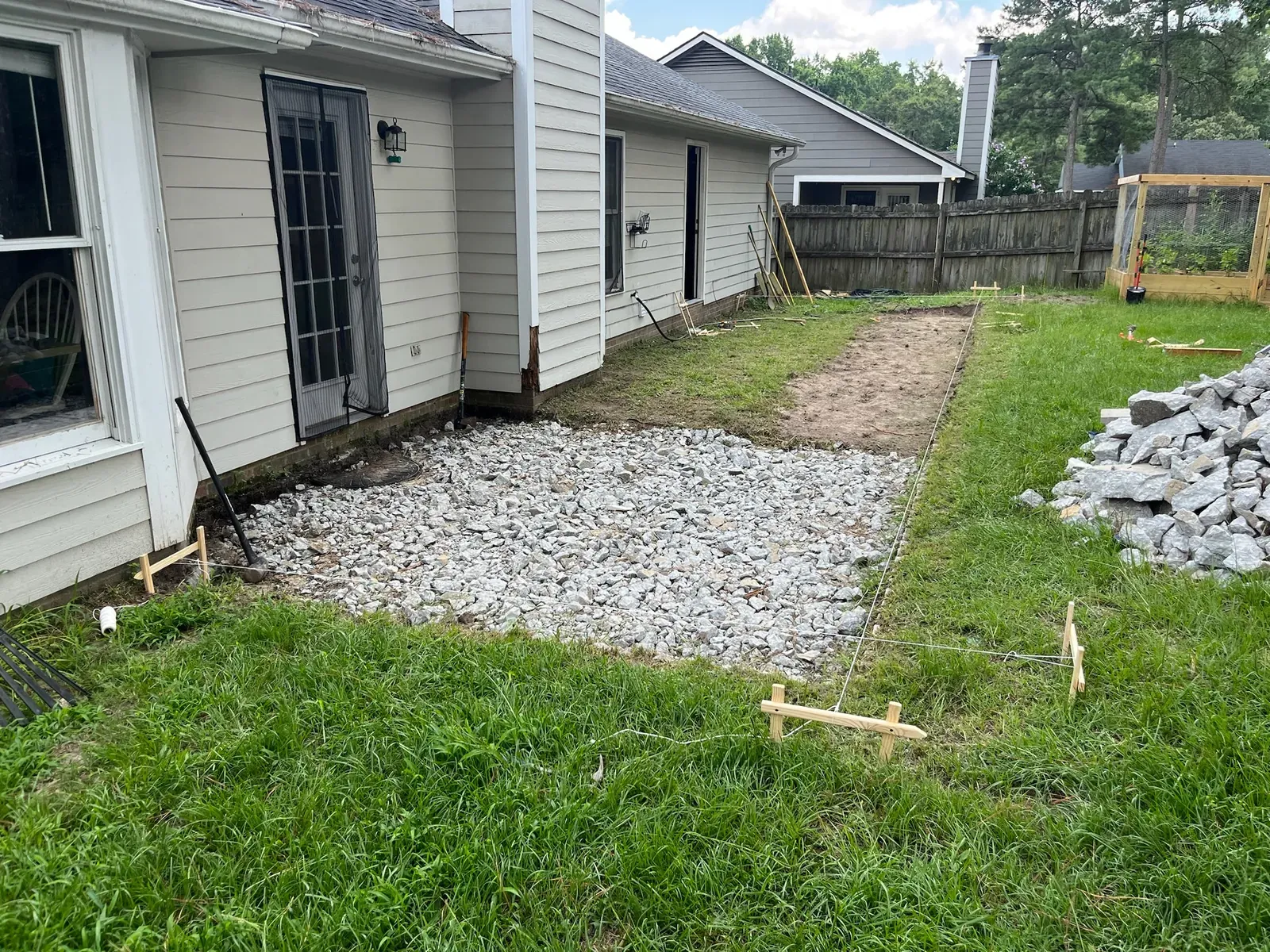 Backyard before deck construction with the site staked out