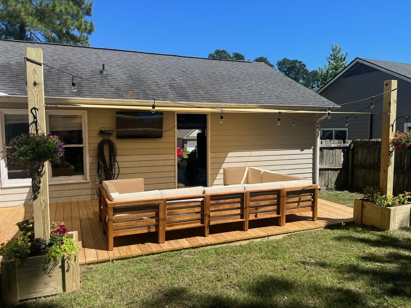 Built-in bench seating with string lights and outdoor TV