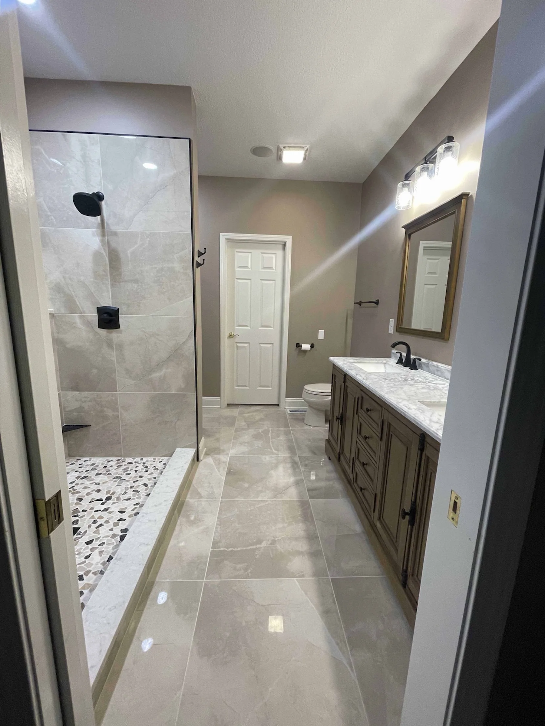 High-end bathroom remodel with built-in cabinetry and walk-in shower