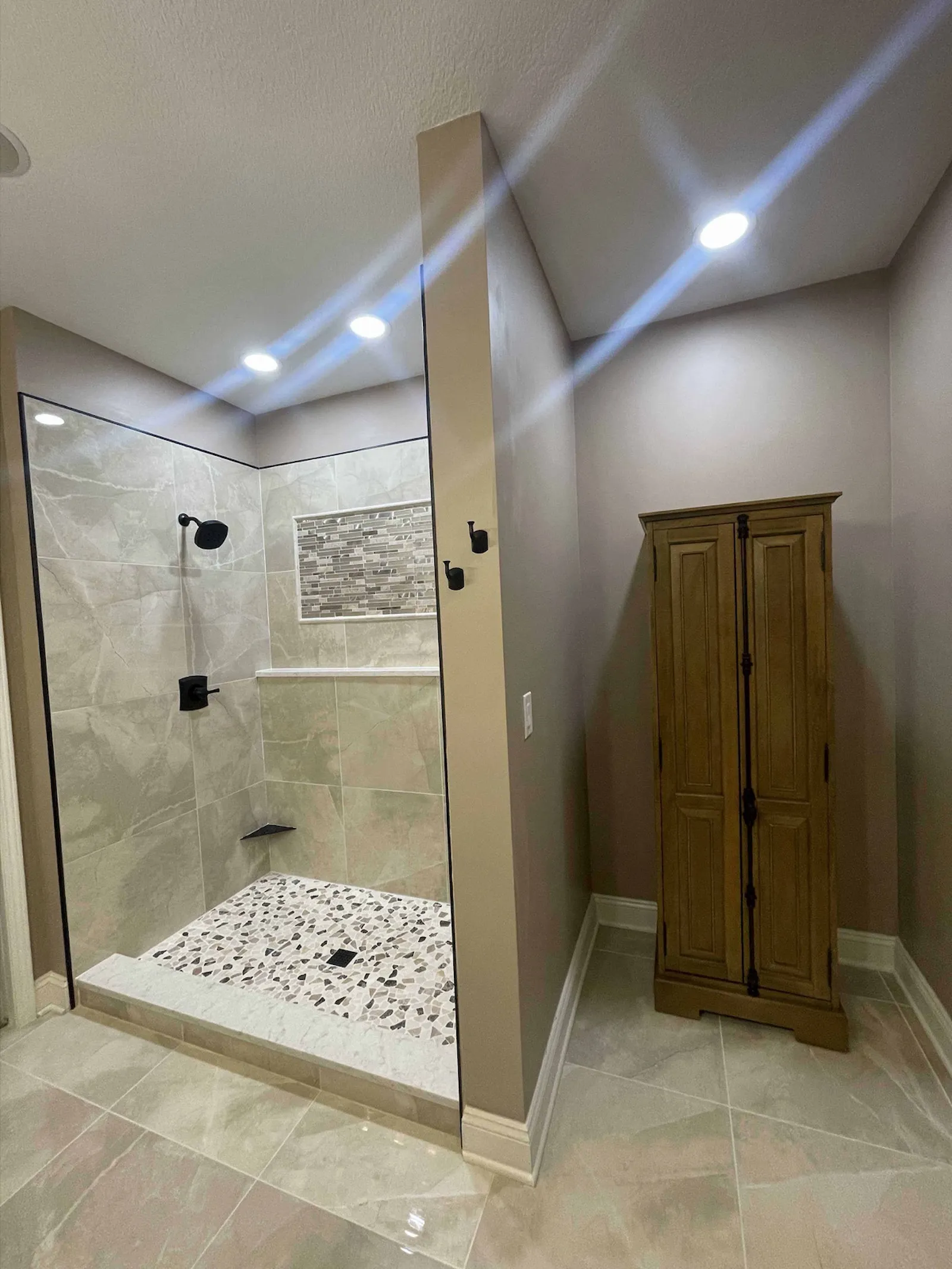 Luxury custom shower with marble look tile