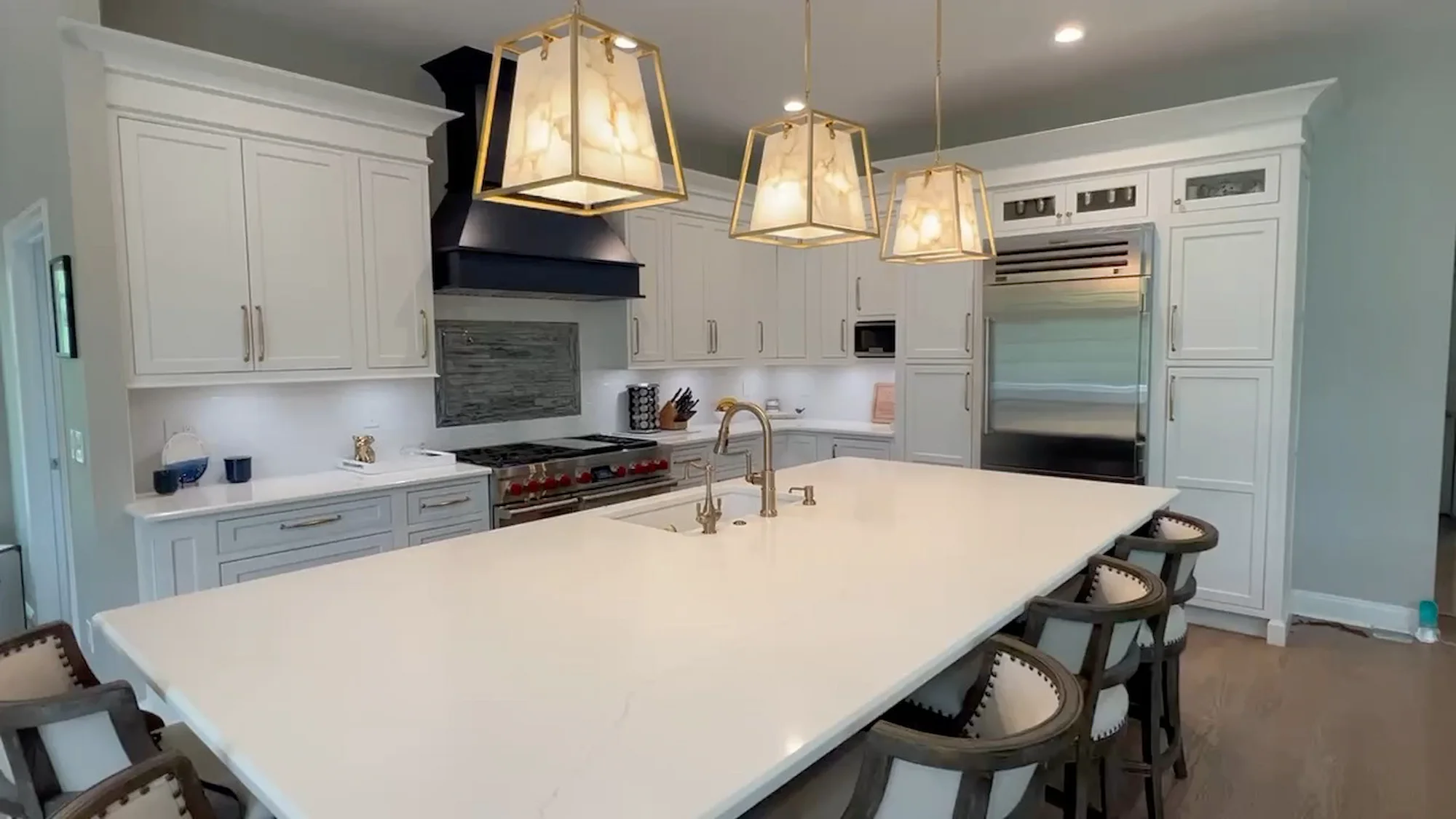 Luxury white kitchen remodel with large island and custom cabinets