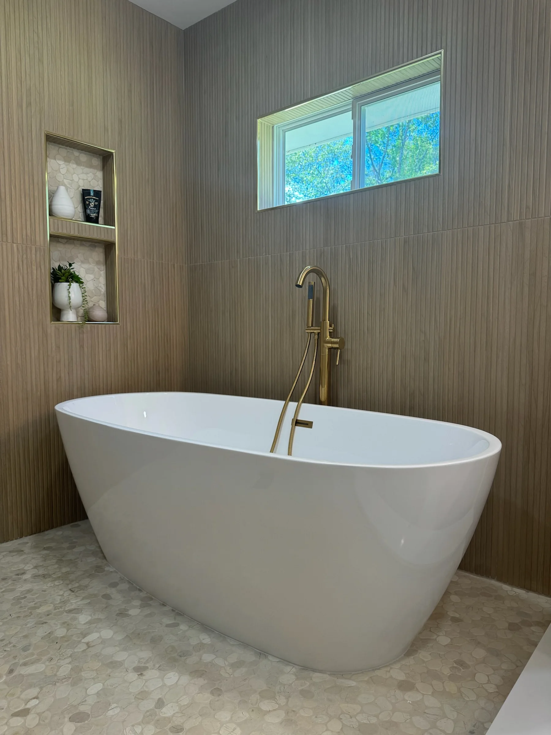 Freestanding tub with gold fixtures