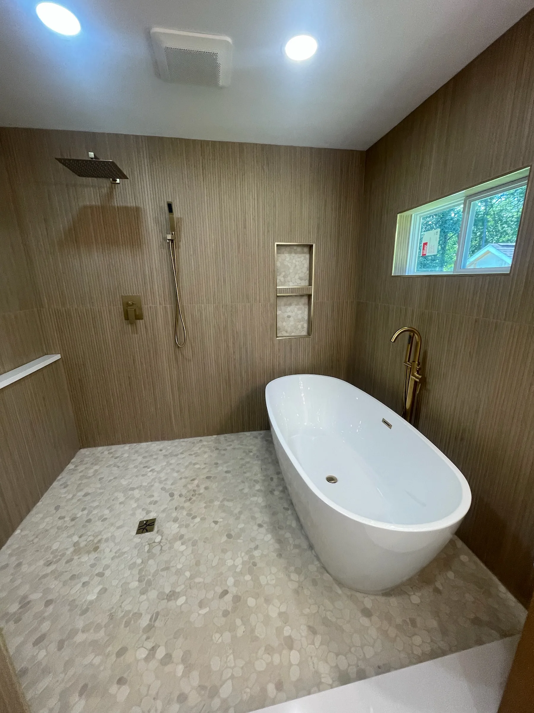 Luxury bathroom remodel with tile finishes and gold fixtures