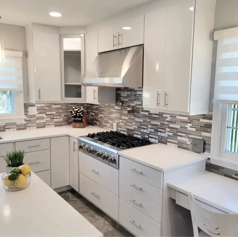 Modern kitchen with floating shelves and white cabinets